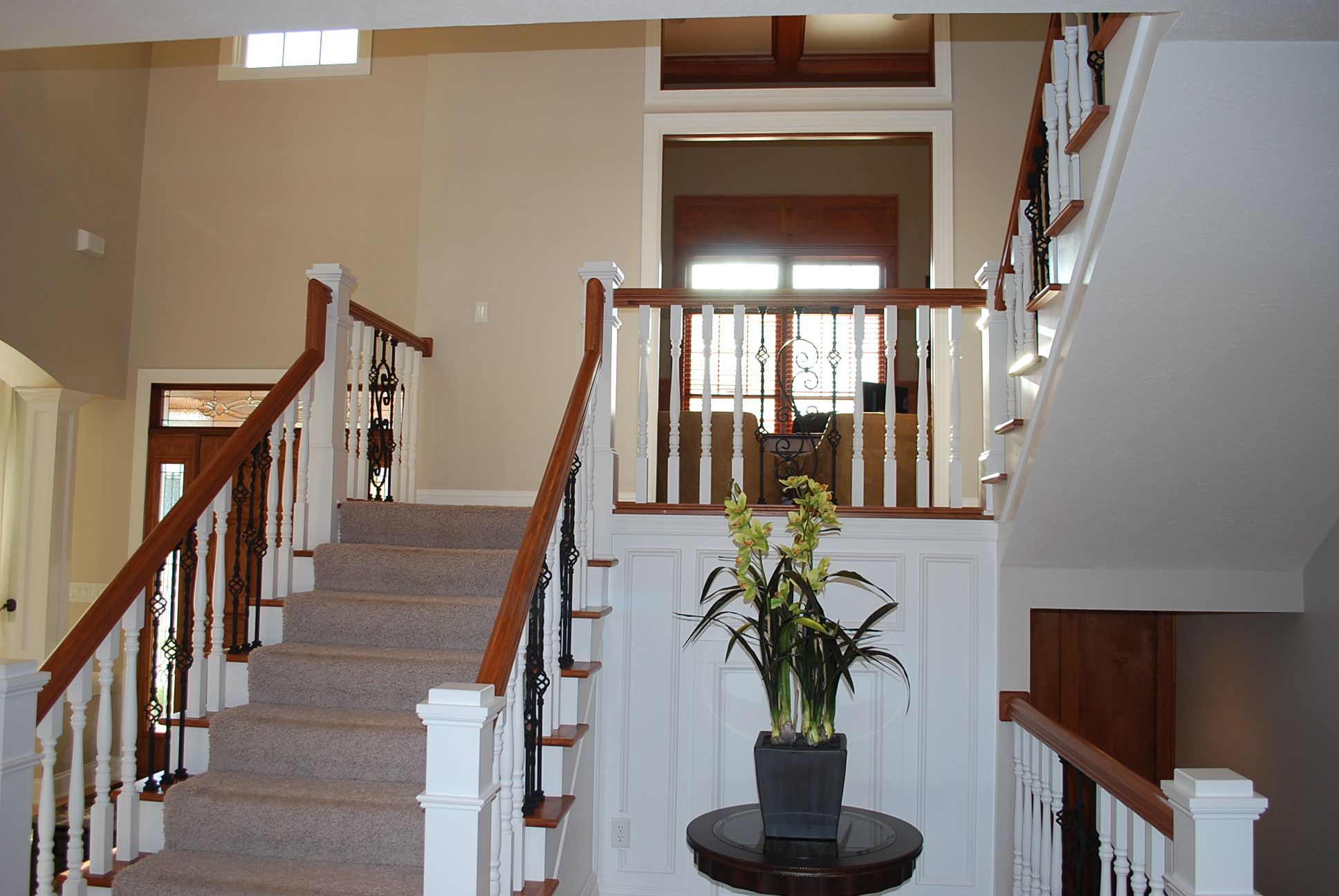 Hallway from entry white and wood.